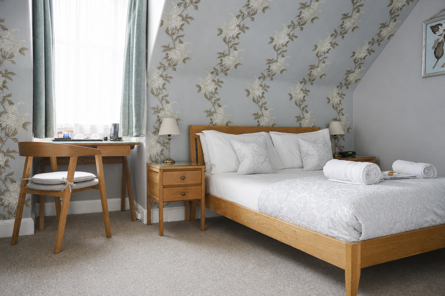 Light guest room with floral wallpaper at Gladstone House